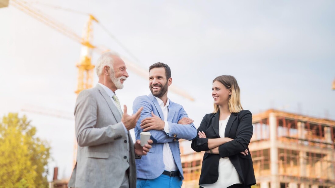 Construction and infrastructure professionals discussing a commercial project.