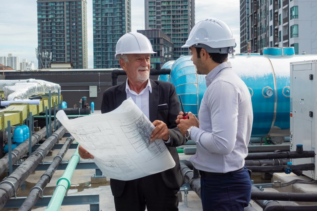 Construction and building services professionals reviewing project plans and specifications.