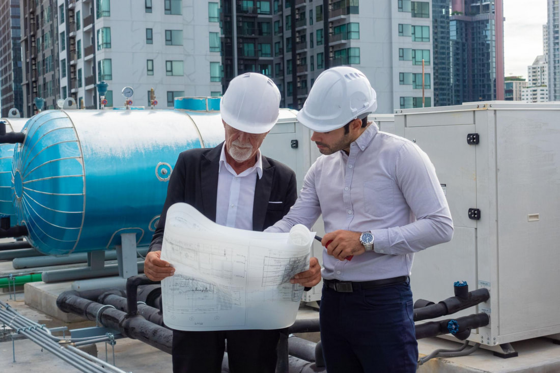 Construction and building services professionals reviewing project plans and specifications.