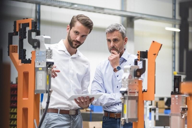  Manufacturing sales and technical discussion beside industrial machinery